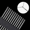 A close-up view of a set of stainless steel self-threading sewing needles against a black background.