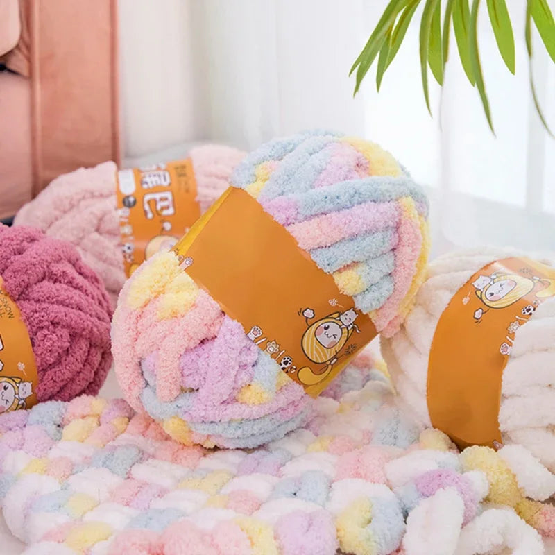 A fluffy, hand-knitted wool finger line scarf in pastel colors like pink, yellow, and blue is displayed on a white surface.