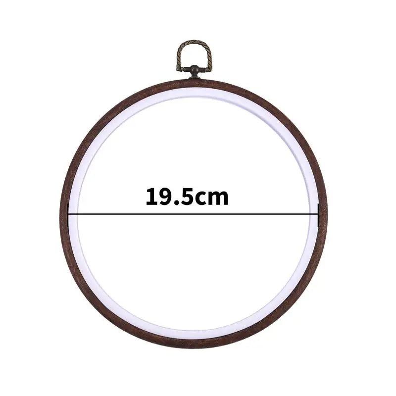 Round wooden embroidery hoop with a light-colored fabric inside