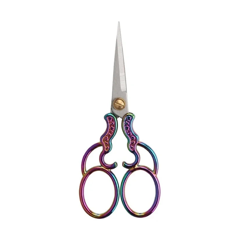 Vintage stainless steel sewing scissors with decorative purple and green handles