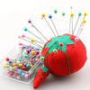 A collection of colorful decorative sewing and pinning needles with various colored tips arranged in a clear plastic containe