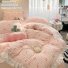 A pink floral bowknot duvet cover set displayed on a bed with pillows and accessories.