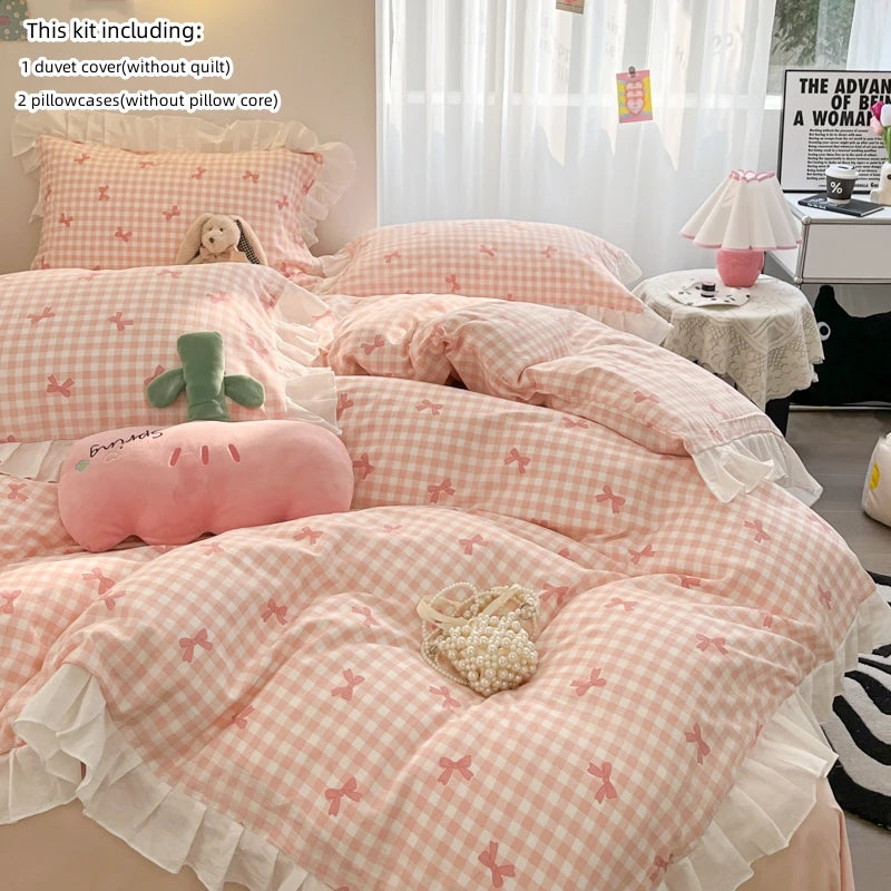 A pink floral bowknot duvet cover set displayed on a bed with pillows and accessories.