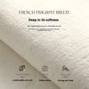 A close-up of a white textile mat showing features like softness, dense fuzz, and anti-slip properties.