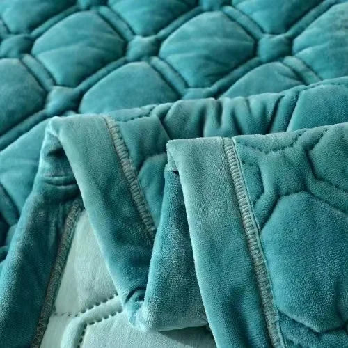 Teal plush velvet quilted blanket folded and draped