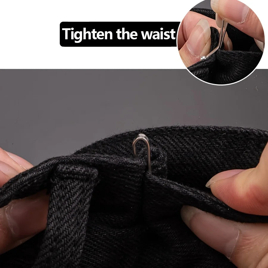 Close-up of a hand tightening an invisible metal lapel clip on black fabric to tighten the waist.