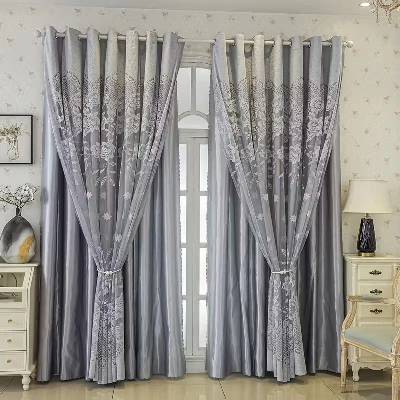 Gray vintage floral blackout curtains hanging in a window with white furniture.