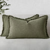 A pair of olive green linen fringe throw pillow covers resting on a light gray sofa.
