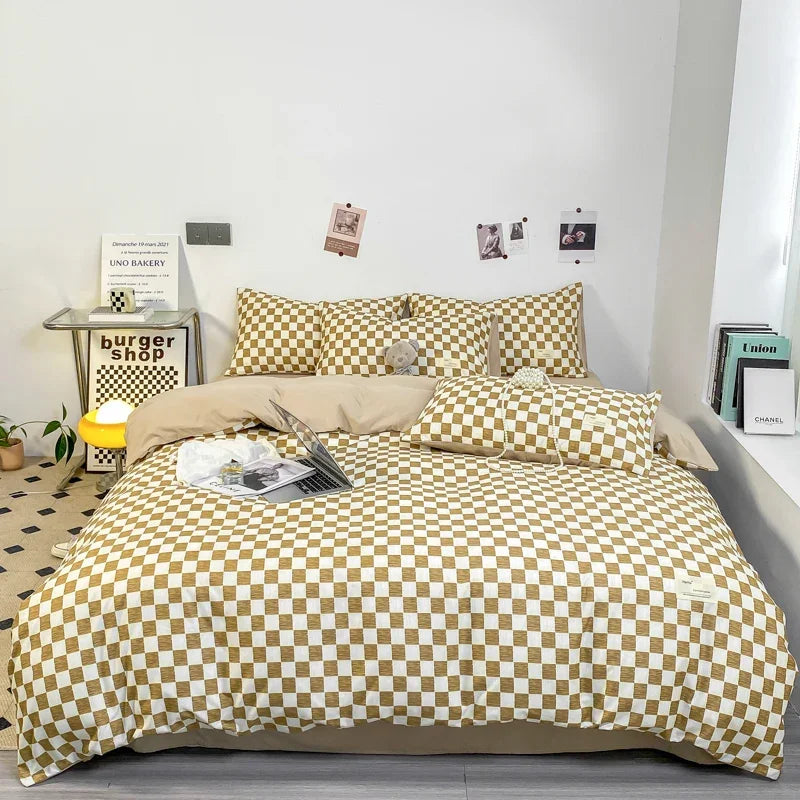 A beige duvet cover with a gold and white checkered pattern displayed on a bed.