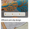 Close-up of a gray fabric with orange and blue leaf patterns showing an anti-slip design detail.