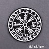 Black embroidered circular patch featuring various ancient symbols and letters on a gray background