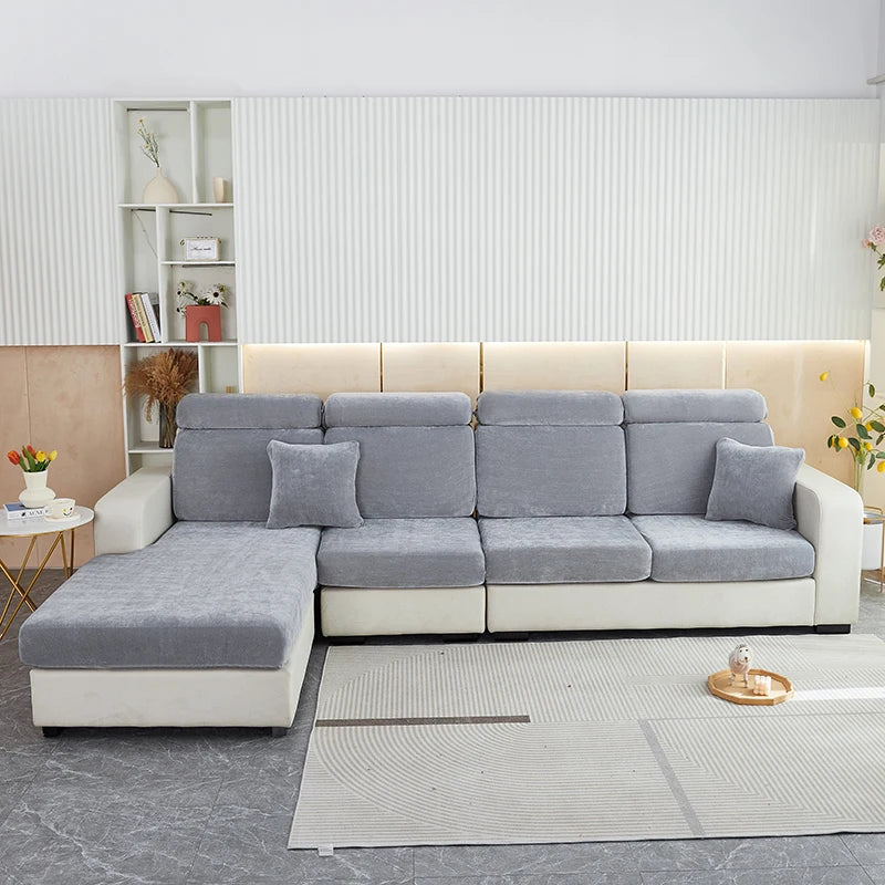 A light gray stretchable chenille sofa cushion cover on a modern sectional sofa in a bright room.
