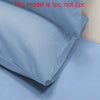 A close-up view of a matte solid color pillowcase folded and displayed on a light surface.