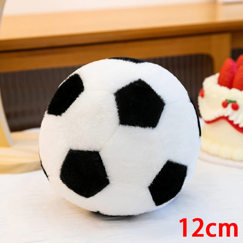 A white and black realistic football plush toy resting on a white surface.