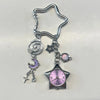 Silver adjustable star-shaped pocket watch keychain featuring a purple moon and a pink-colored clock face