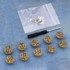 Silver metal button pins are displayed on a translucent pouch against a blue denim background.