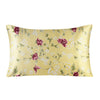 A square silk pillowcase featuring a yellow background with a floral print of pink and white roses and greenery.