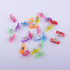 A collection of colorful plastic sewing clips in various shades including pink, yellow, purple, and red.