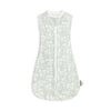 A light green soft cotton baby sleeping bag or swaddle with a zipper and a delicate leaf pattern.