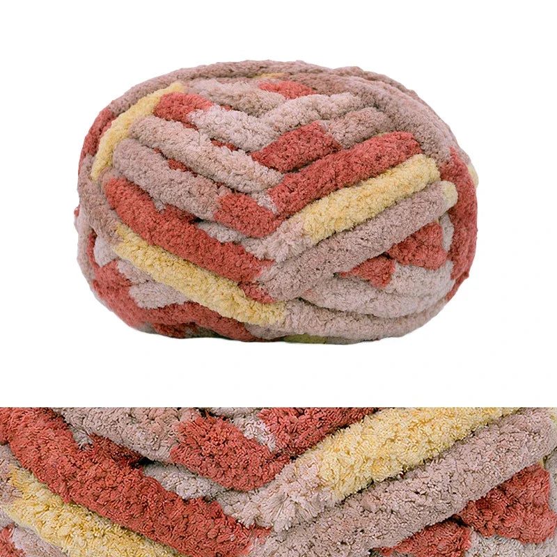 A round, hand-knitted wool finger line scarf with variegated shades of pink, orange, and cream.