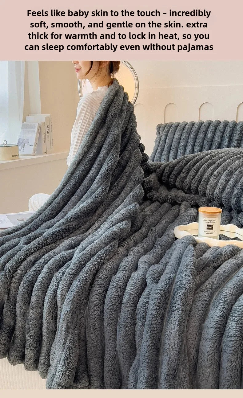 A dark gray faux fur blanket is draped over a bed, emphasizing its soft texture and warmth.