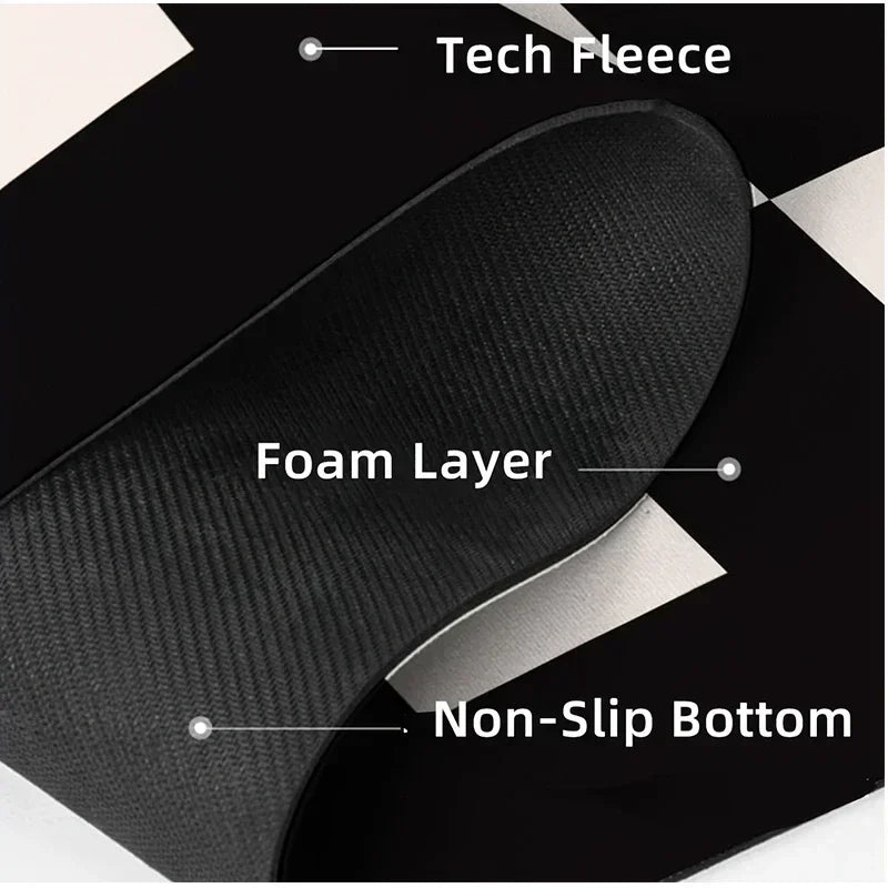 Close-up view of a black non-slip dish drying mat showing layers including tech fleece, foam, and a non-slip bottom.