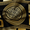 A black fabric with intricate gold geometric patterns and borders.