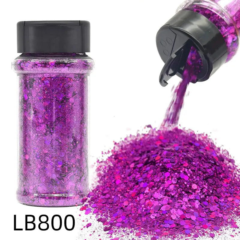 A glass bottle of purple glitter and a hand squeezing more vibrant magenta glitter onto a surface.