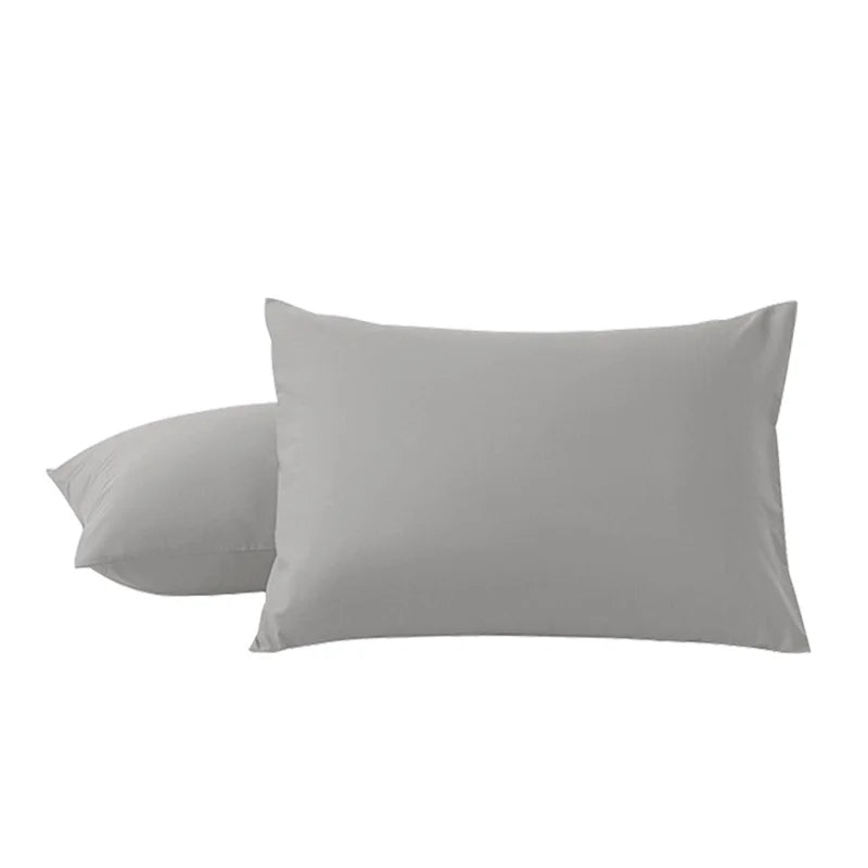 A pair of solid gray microfiber pillow covers lying flat.