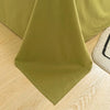 A folded olive green organic cotton flat sheet and pillowcase set lying on a light wooden surface.