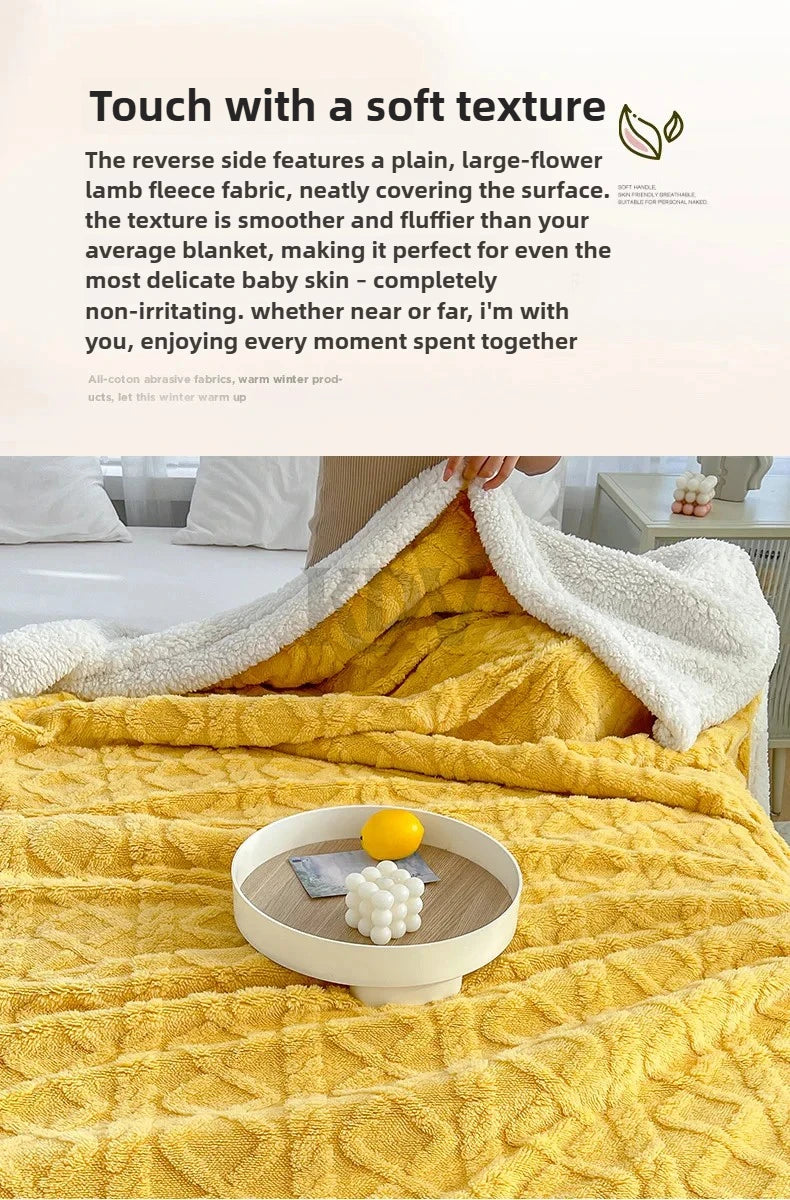 A yellow fleece blanket is shown folded on a bed, with a white blanket draped over it and a lemon resting on the fabric.