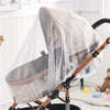 A foldable mosquito net canopy for an infant cot, featuring a sheer fabric and wooden frame.