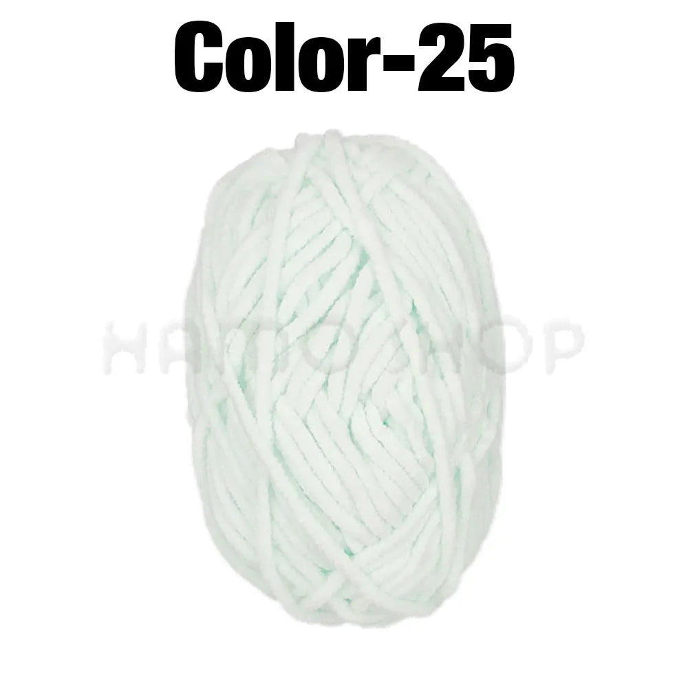A ball of white or light mint green soft velvet chenille yarn for crafting.
