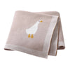 A folded beige cotton infant blanket with a white goose design on it.