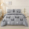 Gray duvet cover set featuring a butterfly print on a bed.
