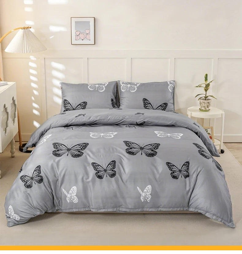 Gray duvet cover set featuring a butterfly print on a bed.