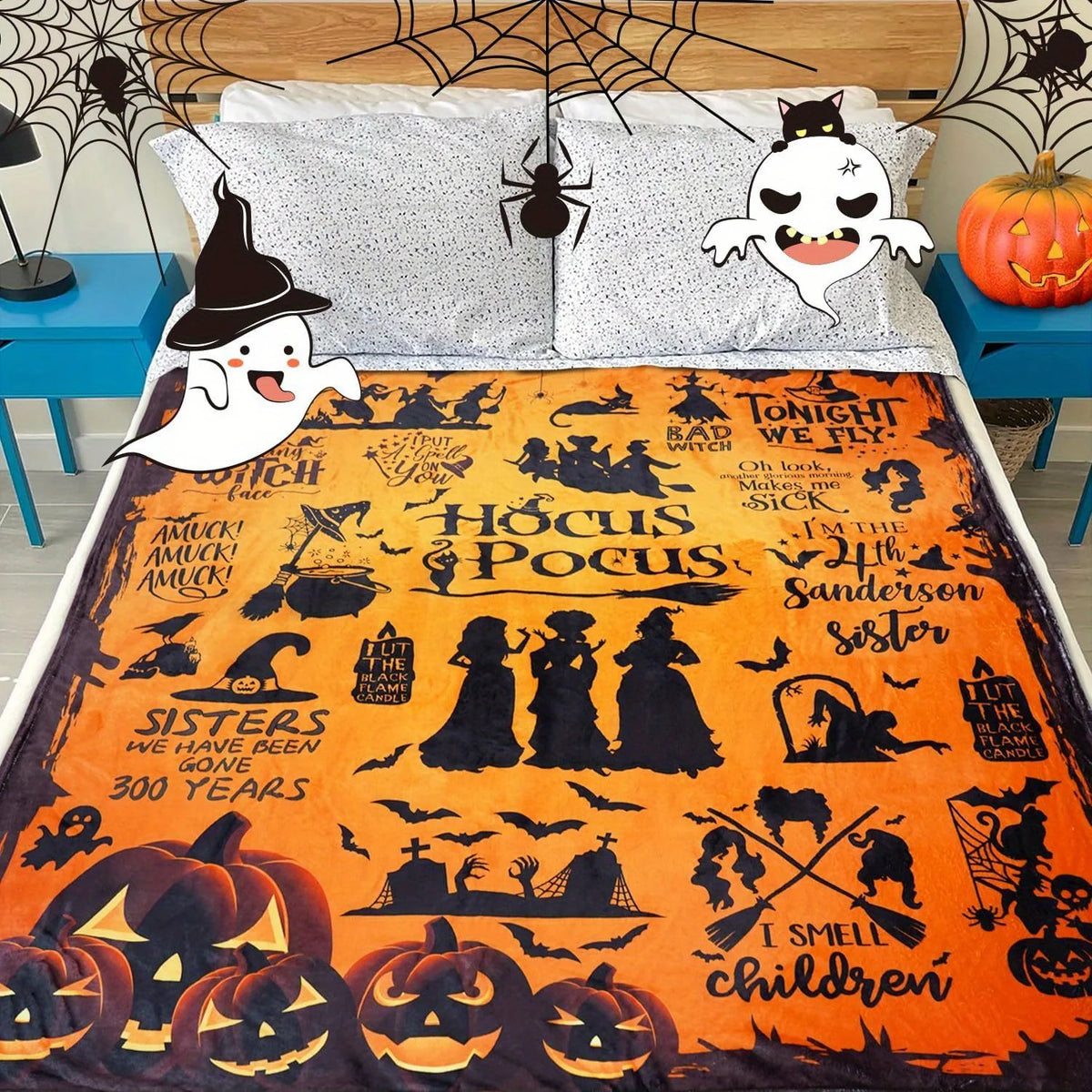 Orange flannel blanket featuring a Halloween design with witches, bats, pumpkins, and spooky silhouettes.