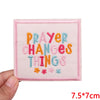 Pink embroidered patch with the text Prayer Changes Things in orange, teal, and pink thread.