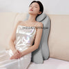 A woman is lying down, resting her head on an ergonomic memory foam wedge pillow.