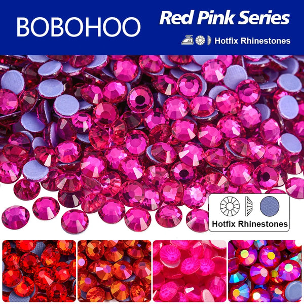 A collection of red pink hotfix rhinestones and glass decorations for crafting.