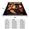 A Halloween themed blanket featuring a horror design on a dark background.