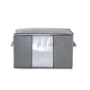 A gray portable quilt and clothing storage bag with a clear window.