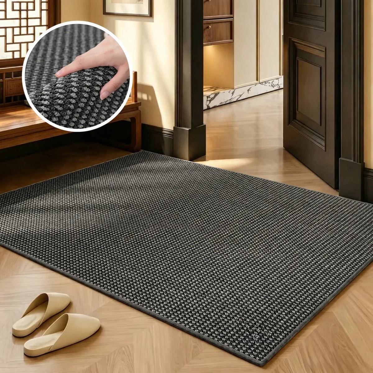 A rectangular black faux sisal runner rug placed on a light wood floor with a wooden bench and a dark door frame visible.