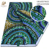 A bolt of grand wax print fabric featuring intricate green, blue, and gold patterns.