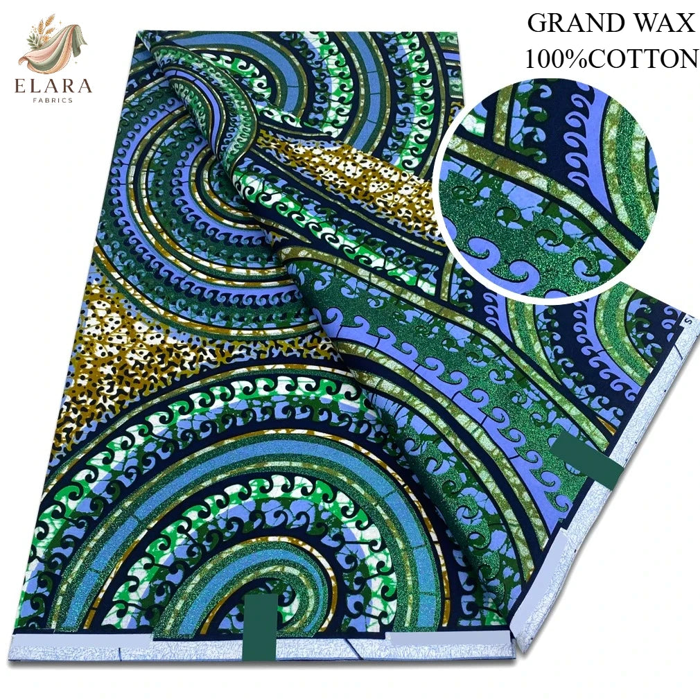 A bolt of grand wax print fabric featuring intricate green, blue, and gold patterns.