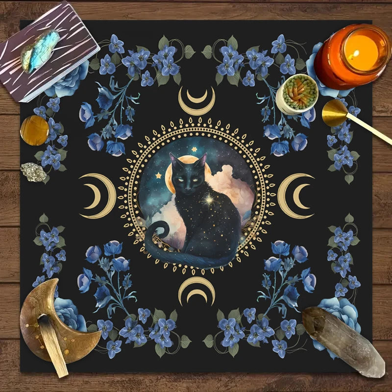 A dark mat featuring a central silhouette of a black cat surrounded by crescent moons and blue floral elements.