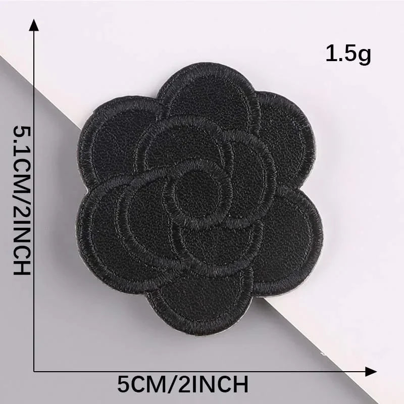 A set of five black embroidered leather patches with self-adhesive backing, measuring 5cm by 5.1cm each.