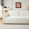 A cream-colored geometric quilted sofa cushion cover displayed on a white sofa in a bright room.