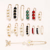 A collection of adjustable pearl and bead brooches and pins in various colors and styles.
