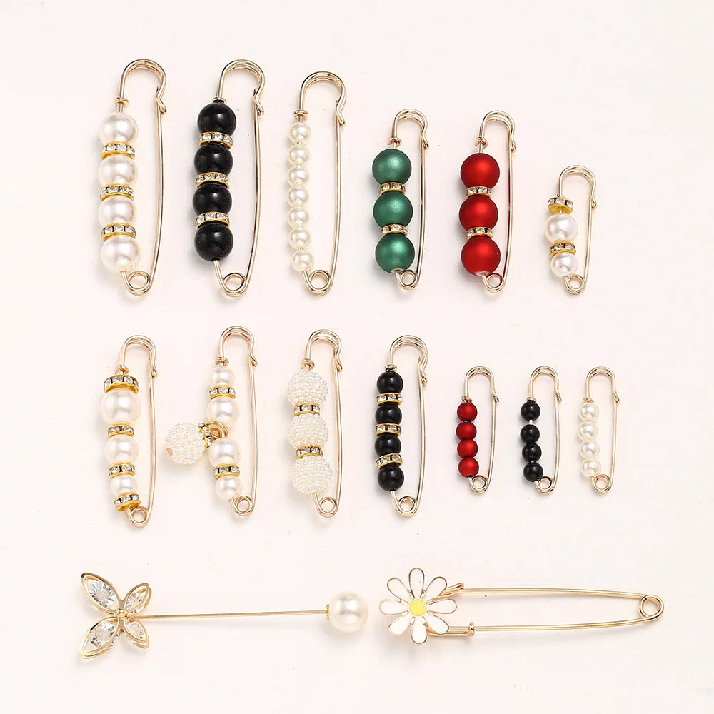 A collection of adjustable pearl and bead brooches and pins in various colors and styles.